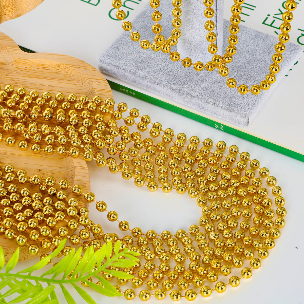EOBOH 33-inch gold Mardi Gras beads laid out for display, great for party outfits.