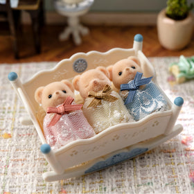 Epoch Sylvanian Biscuit Bear Triplets doll in lace dress for dress-up storytelling.