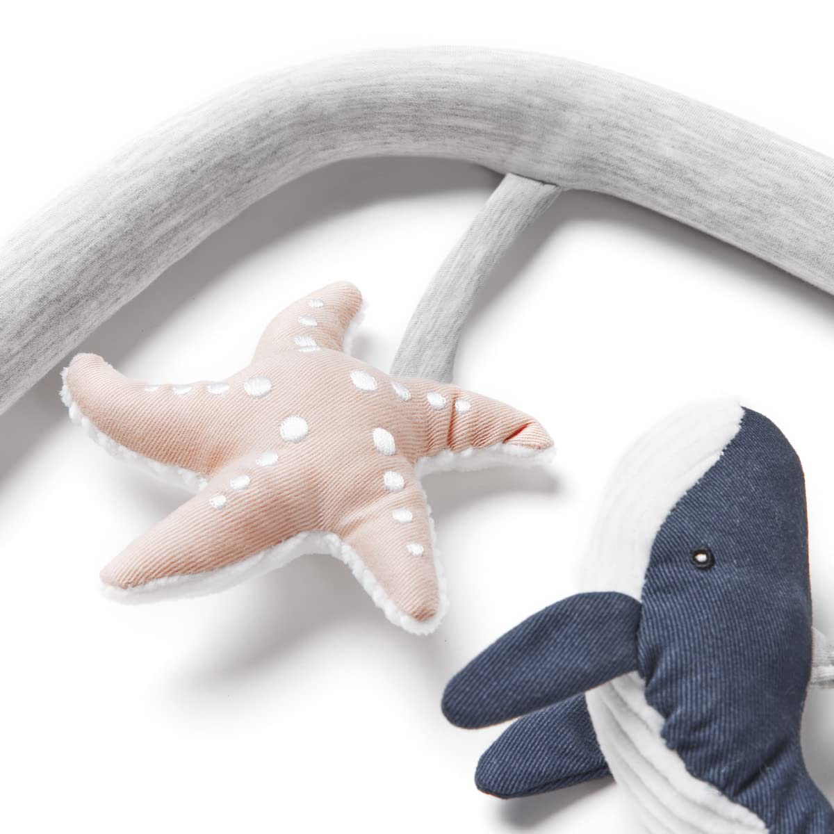 Ergobaby Evolve Toy Bar whale rattle encourages grasping and listening.