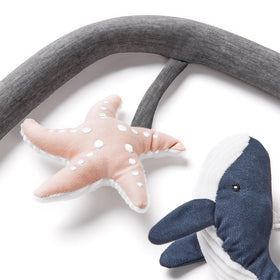 Ergobaby Evolve Ocean Wonders whale rattle promotes reaching and exploration with gentle sounds
