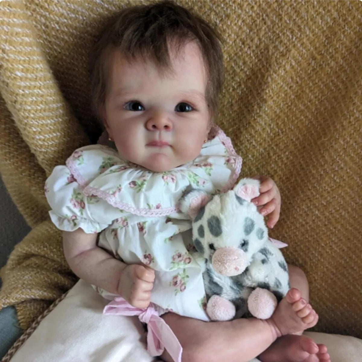FASMAS Reborn baby doll in floral dress for nurturing roleplay and display.