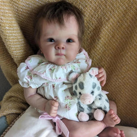 FASMAS Reborn baby doll in floral dress for nurturing roleplay and display.