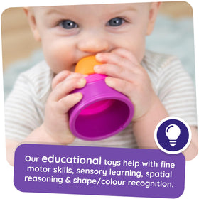 Fat Brain Toys Dimpl Stack toddler hands gripping for dexterity development.
