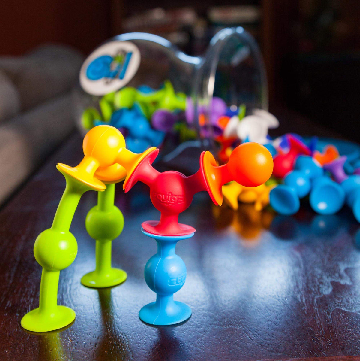 Bath time with Fat Brain Toys Squigz Deluxe suction toys clinging to tub walls