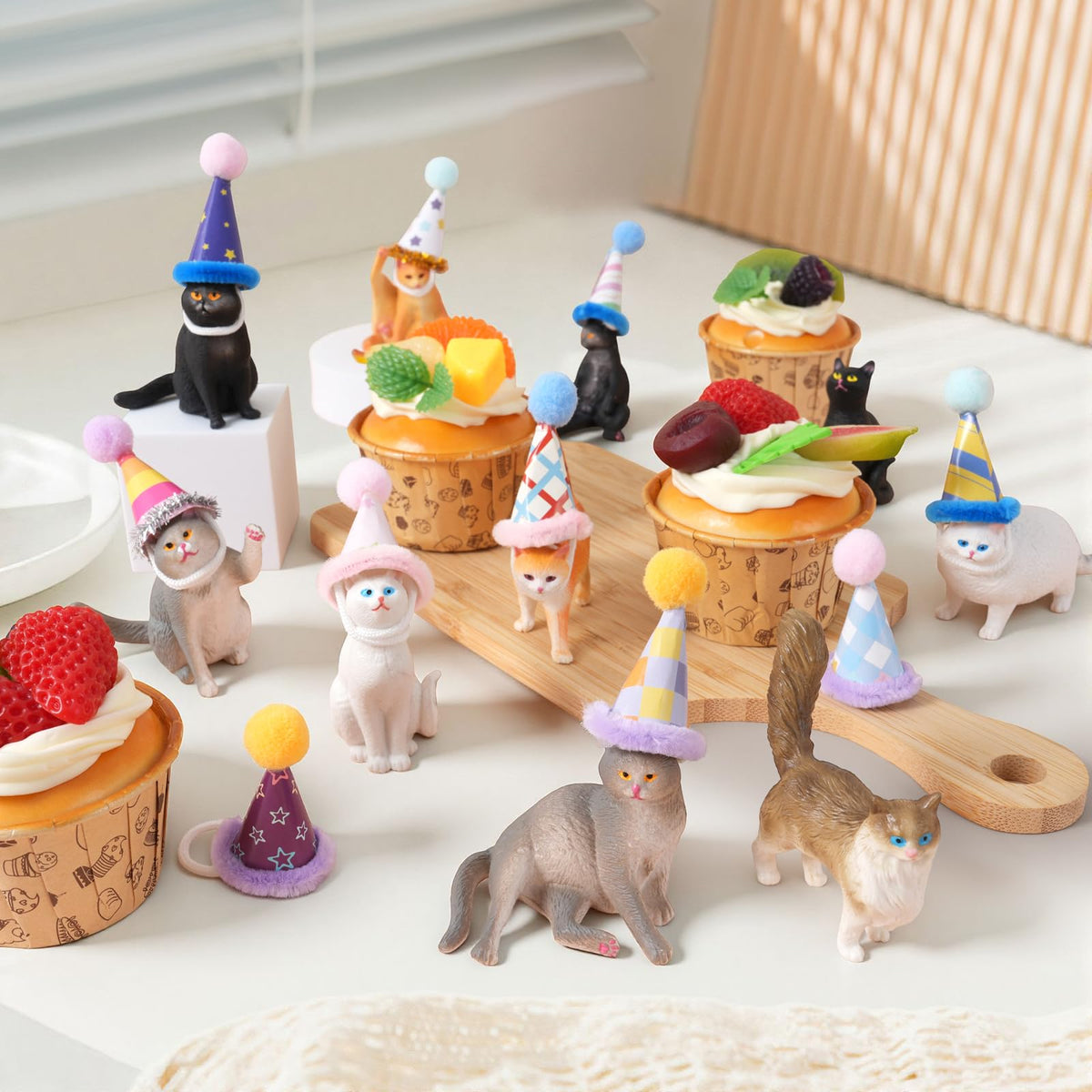 FCKLVMC cat party centerpiece featuring detailed figurines and hats.