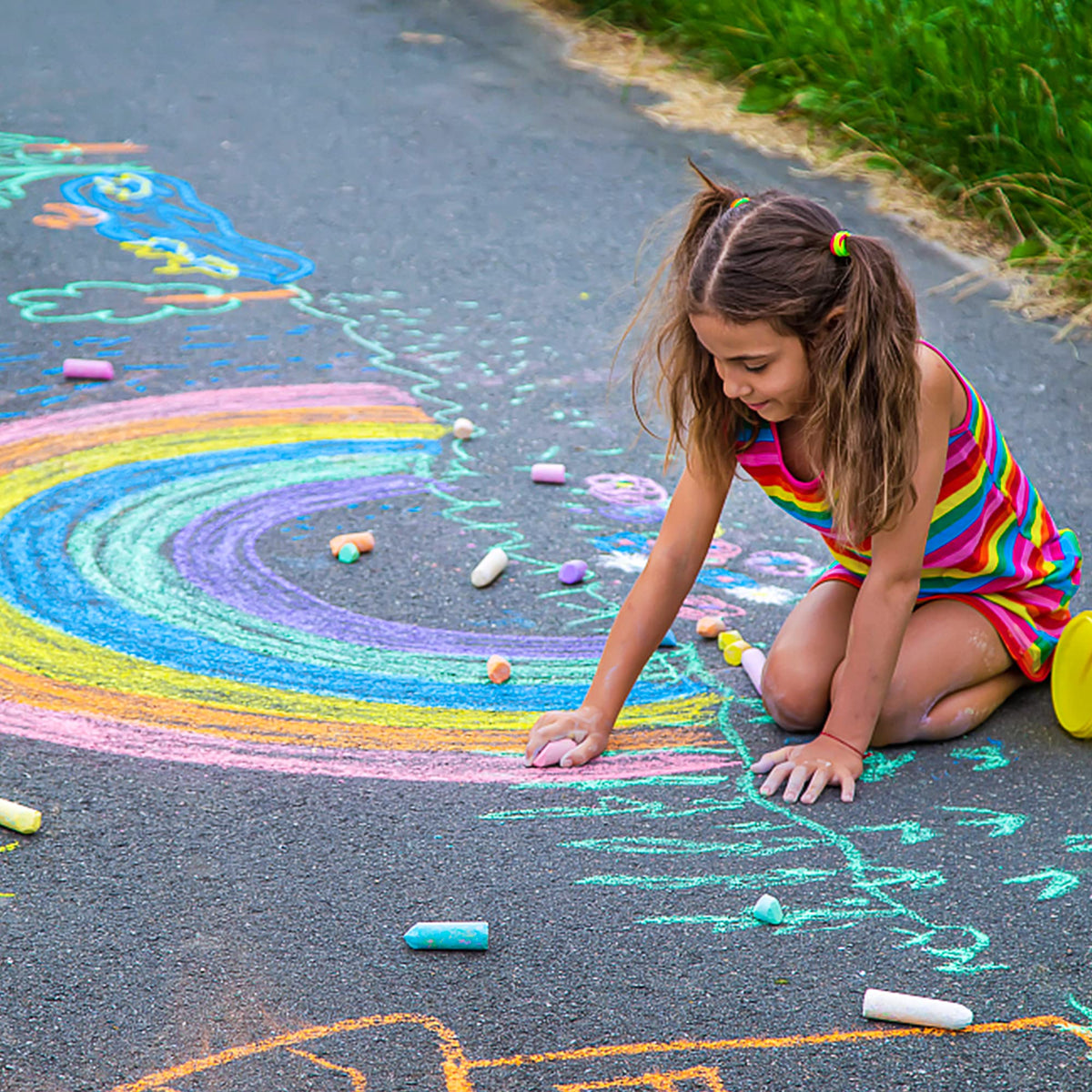 Feela kids drawing on sidewalk with vibrant outdoor colors.