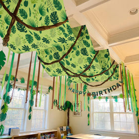 Feifeiya jungle banner with forest leaves elevates ceiling visuals for birthday celebrations.