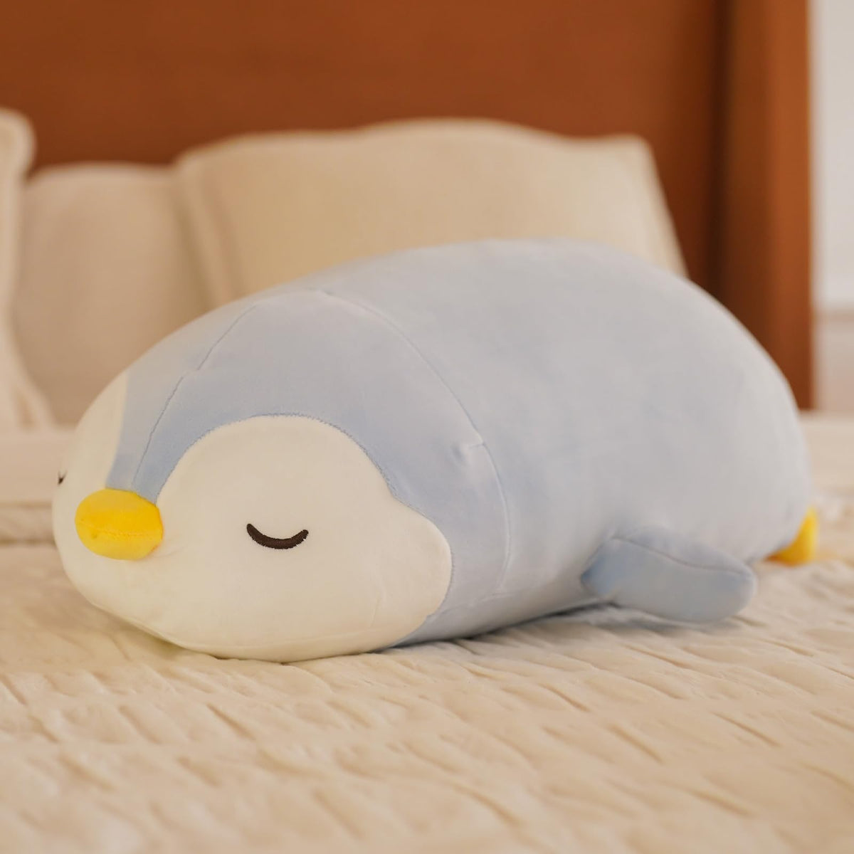 Side view of FFxiong penguin plush pillow showcasing size