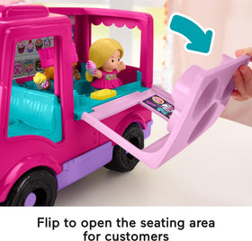 Umbrella table and two chairs accompany the cupcake truck.