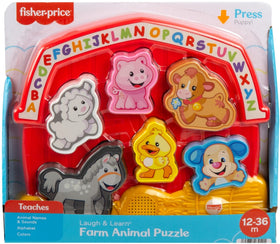 Child developing hand-eye coordination with Fisher-Price farm puzzle