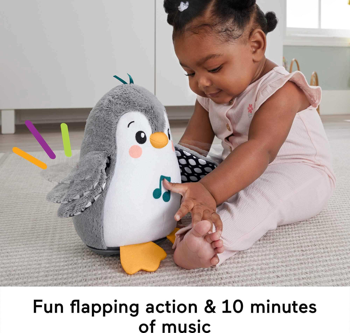 Fisher-Price Flap & Wobble Penguin during tummy time encourages reaching and self-directed play.
