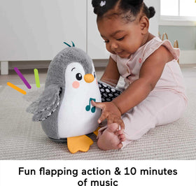Fisher-Price Flap & Wobble Penguin during tummy time encourages reaching and self-directed play.