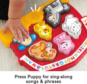 Puppy button on Fisher-Price Laugh & Learn puzzle offering phrases and tunes