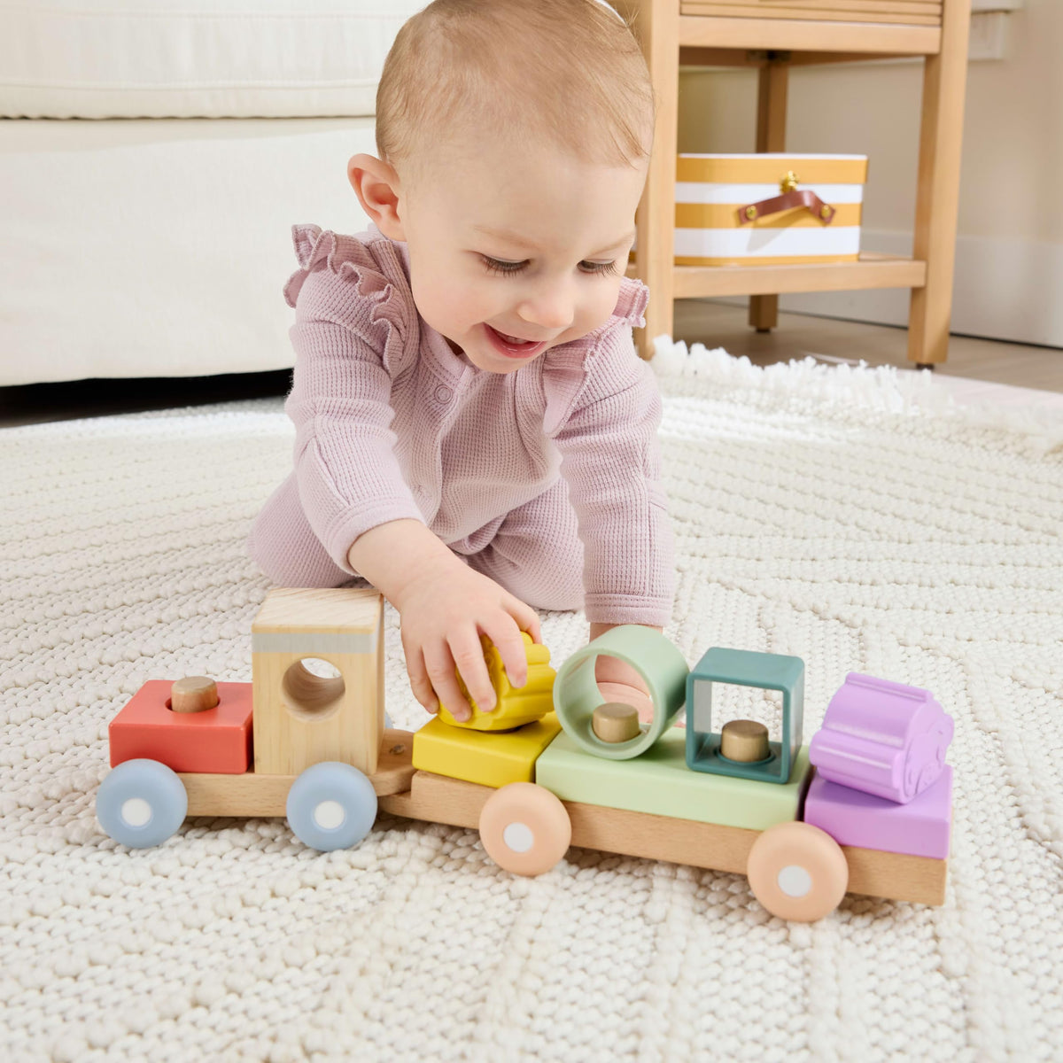 Fisher-Price wood train with blocks encourages hand-eye coordination during play.
