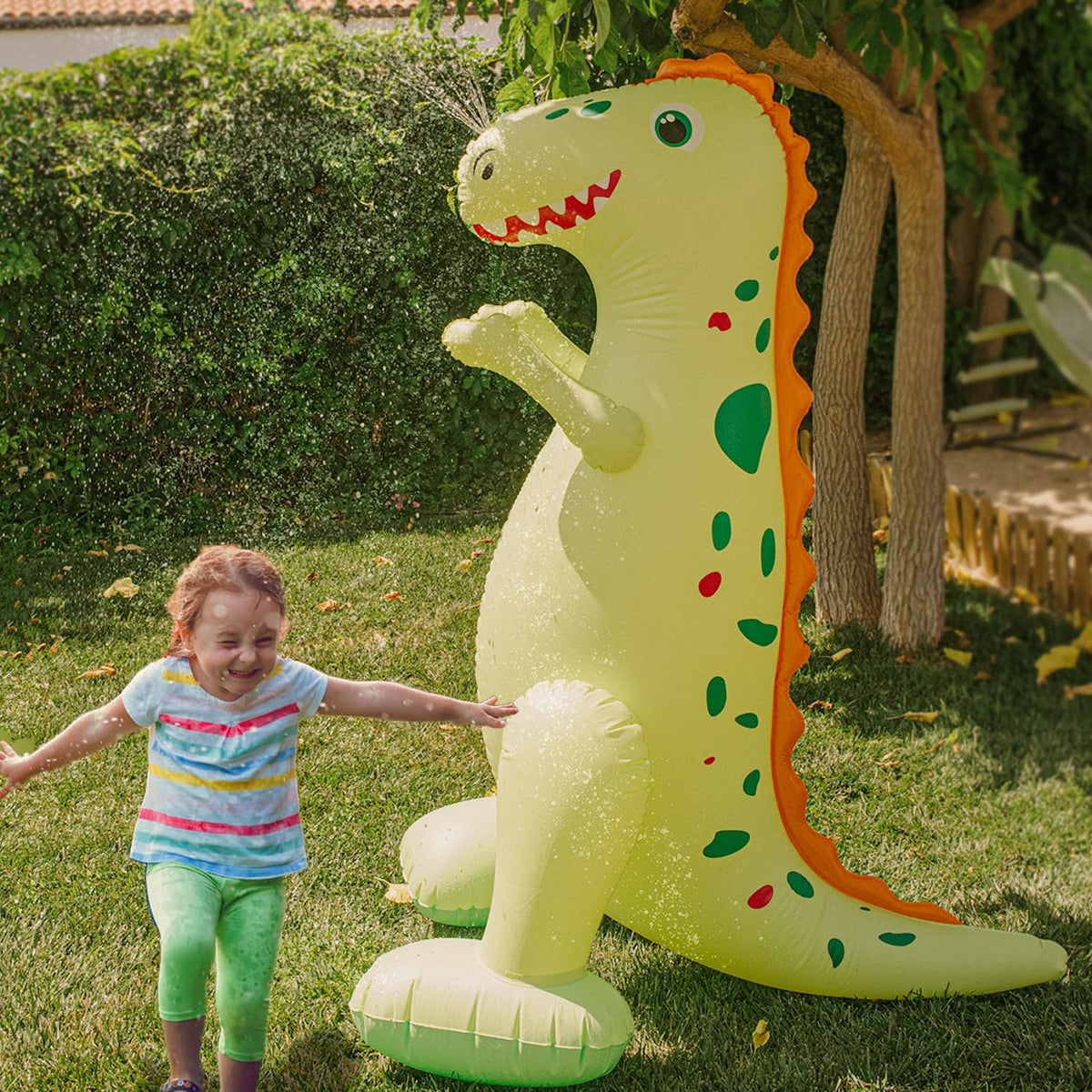 Float Joy dinosaur sprinkler with belly hose connection for quick setup.