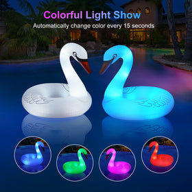 FlyfreeU Swan float lit at dusk with color-changing lights.