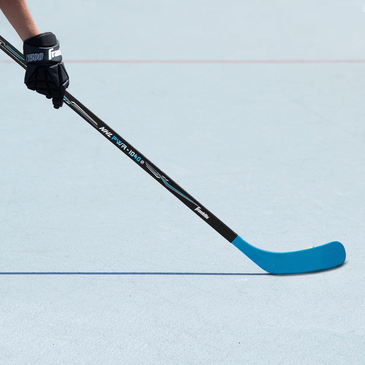 ABS blade against pavement surface illustrating durability against rough outdoor surfaces.
