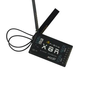 FrSky X8R receiver front view showing compact body and dual antennas.