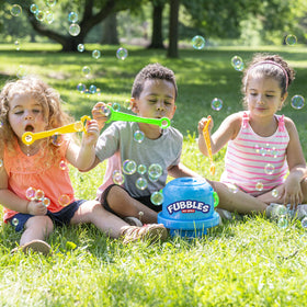Children enjoying Fubbles bubbles outdoors with the No-Spill Bucket