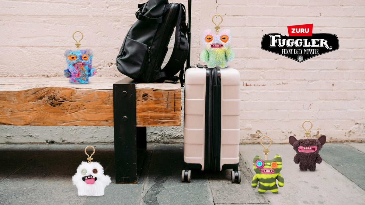 Fuggler Series 3 on luggage image showcases travel-ready, conversation-starting accessory.