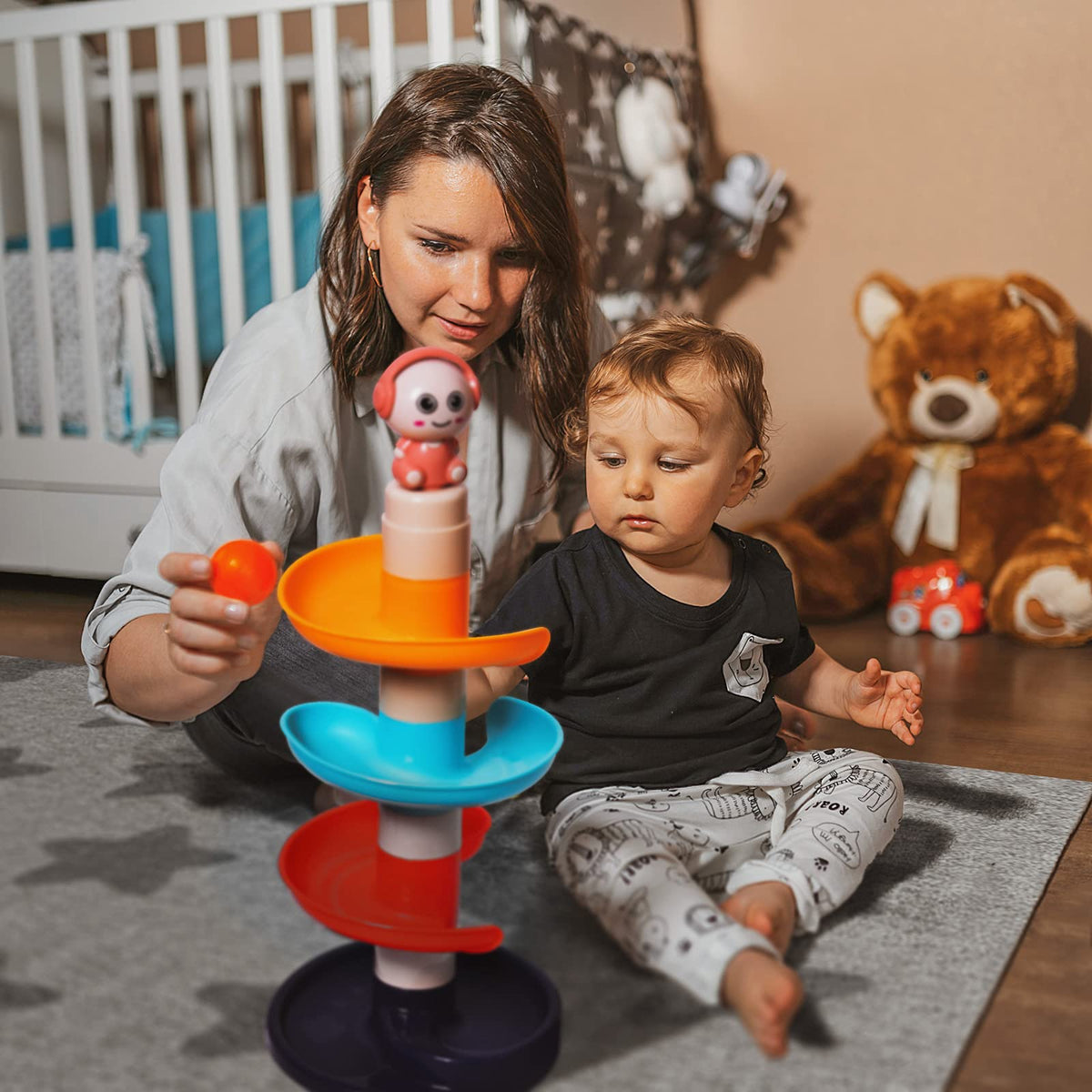 Fun Little Toys hand-eye coordination benefits observed as balls drop and ramps respond.