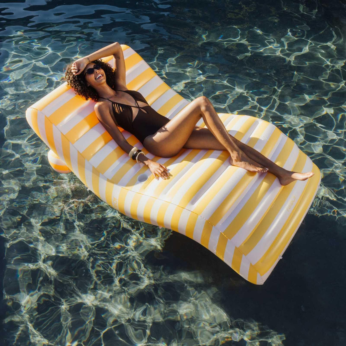 FUNBOY chaise lounger with built-in cup holder keeps drinks within reach.