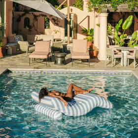 FUNBOY giant chaise lounger shown on lawn for sunny backyard relaxation.