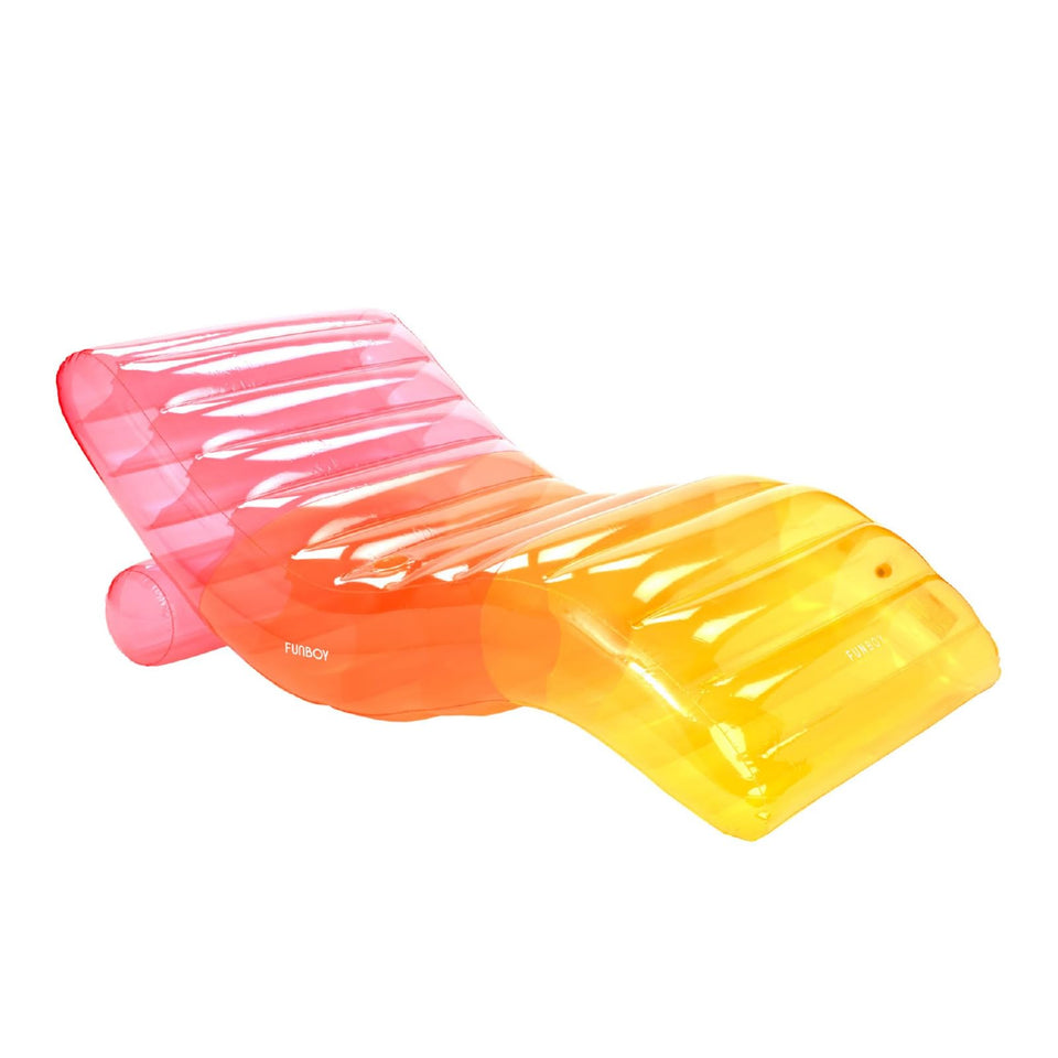 FUNBOY giant inflatable rainbow chaise lounger on water for ultimate relaxation.