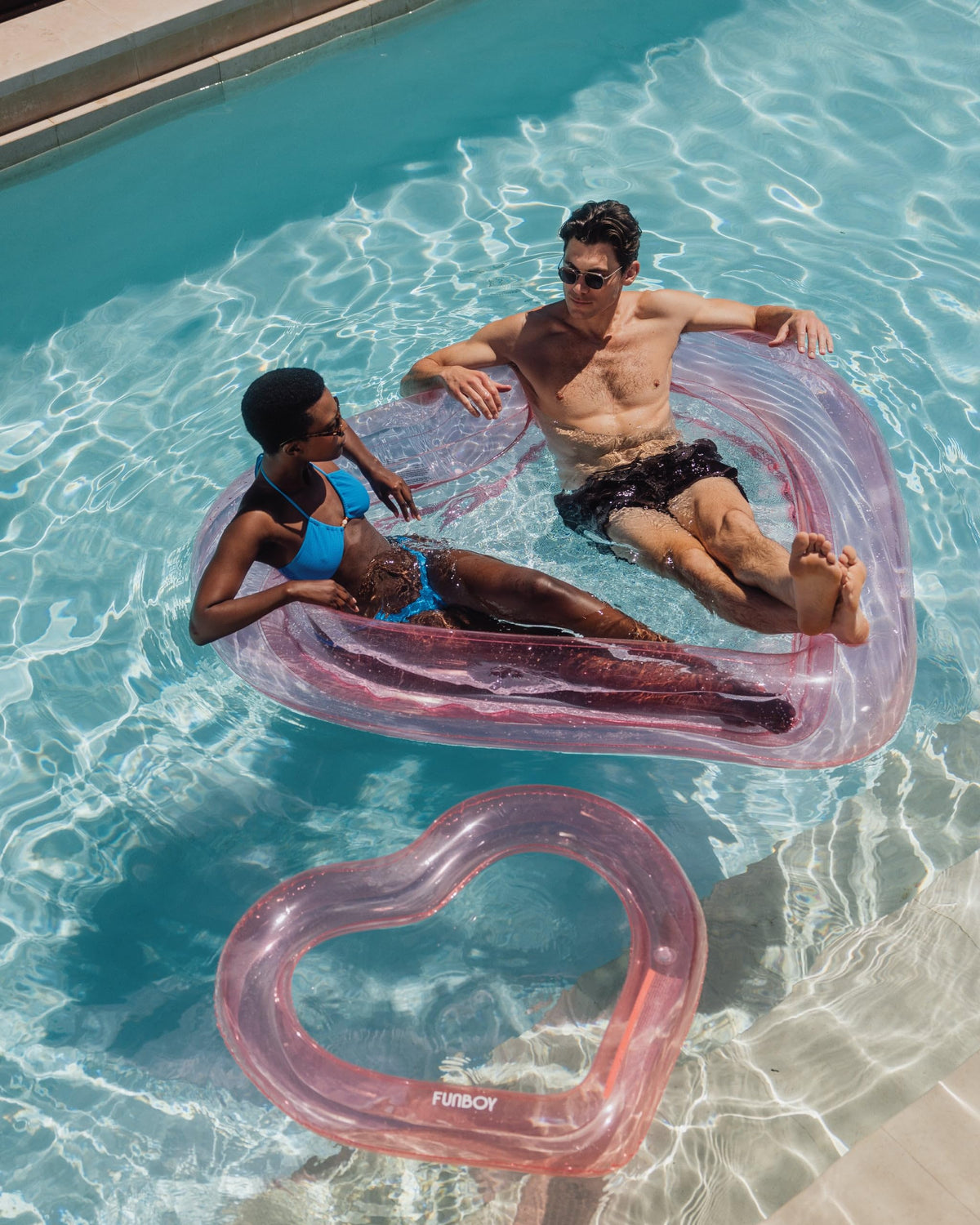 FUNBOY Summer pool party scene highlights versatile float for guests and lounging.