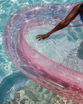 FUNBOY Two adults on heart mesh lounger enjoy roomy comfort during sunny pool days.