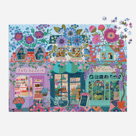 Galison Open for Blossoms puzzle wisteria-draped awnings and colorful storefronts, great for cozy evenings.