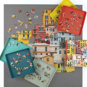 Galison stackable puzzle trays provide space-saving organization during long projects.