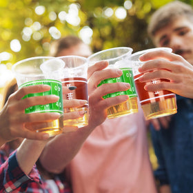 Gatherfun football-pattern cups with yard-line design for themed tables.