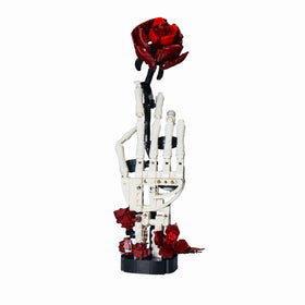 Generic RITTSUN skull rose building set features a bone-white hand and red rose for Gothic desk decor.