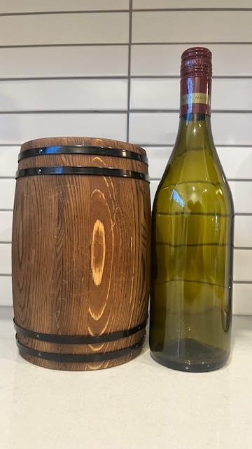 Generic wine barrel piggy bank with lock and key emphasizes secure savings at home.