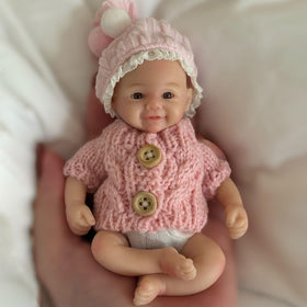 Gileutay reborn doll silicone skin texture closeup highlights soft lifelike surface.