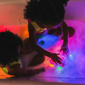 Bright colors on Glo Pals cubes glow when wet for engaging learning.
