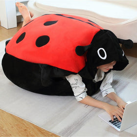 GLOTOYS wearable ladybug pillow shell, plush comfort for lounging and cozy relaxation.
