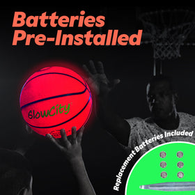 GlowCity glow-in-the-dark basketball held by a kid at dusk.