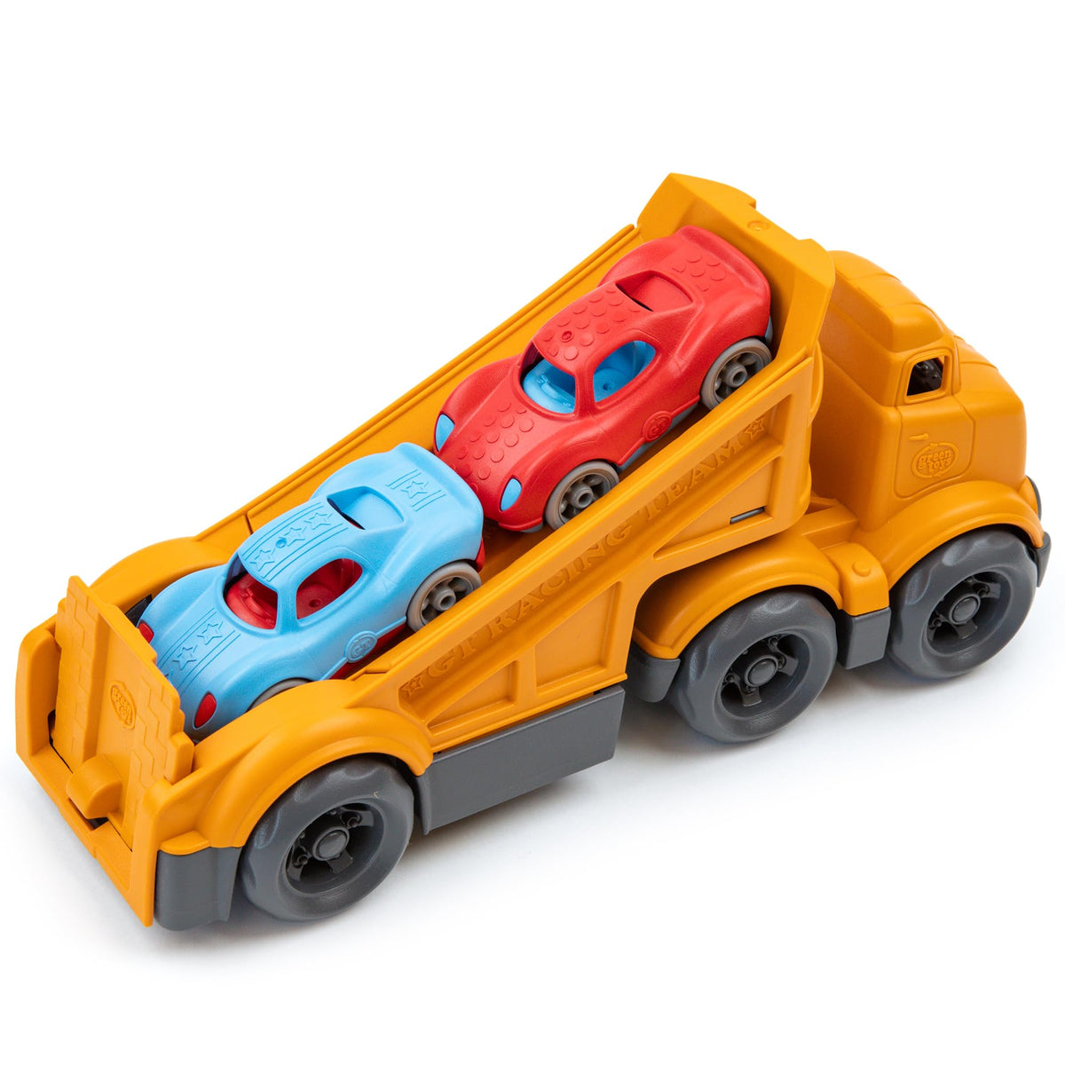 Green Toys racing truck held by a child to show size and scale.