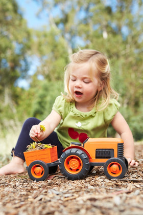 Green Toys Tractor orange tires grip carpet or grass for stable play.