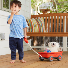 Green Toys Wagon Orange CB child pulling action supports mess-free transport of toys.