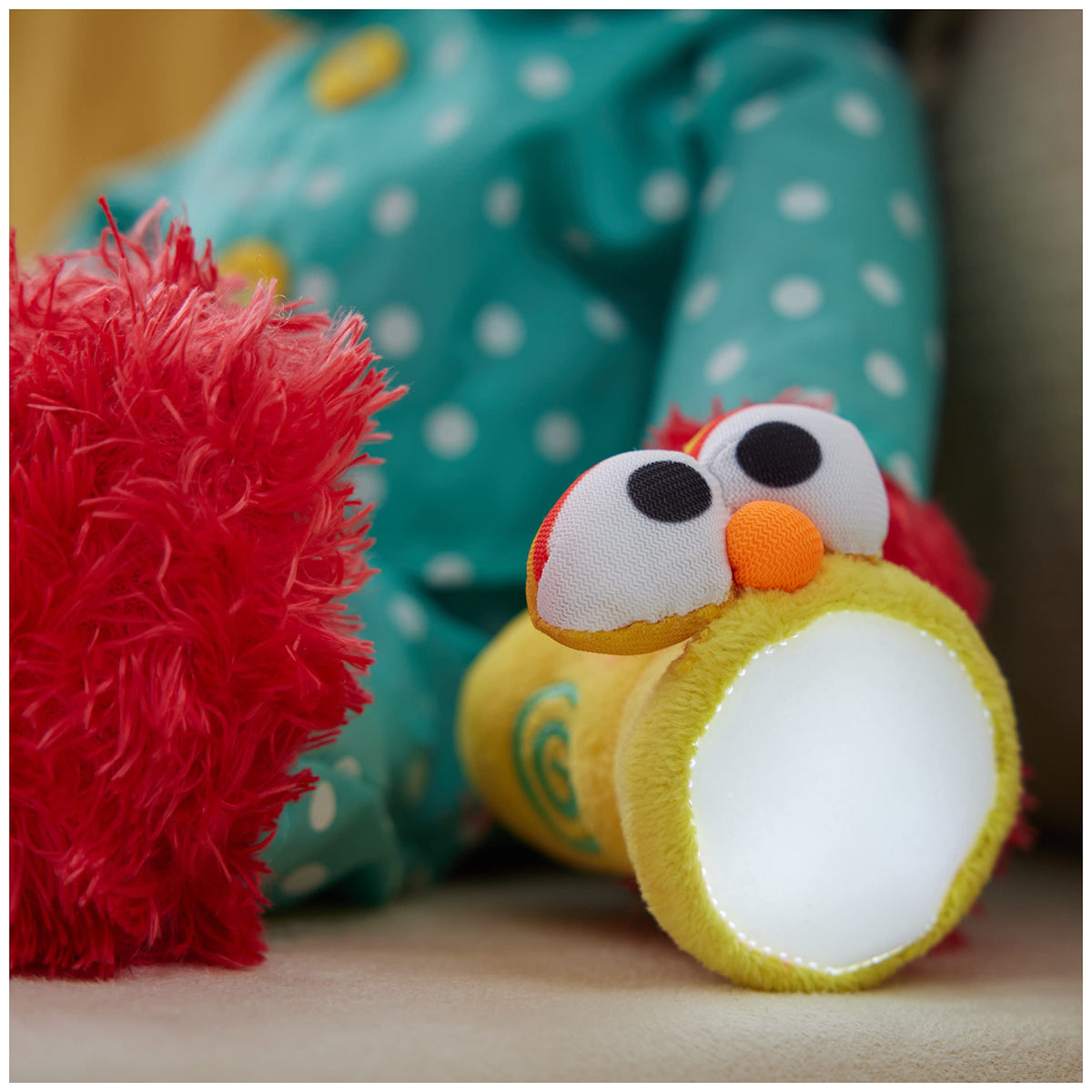 Elmo with a glowing flashlight provides a gentle LED light for evenings.