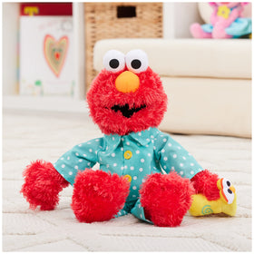 Elmo in teal polka-dot pajamas glows softly for nighttime fun.