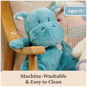 GUND Oh So Snuggly Hippo teal shown beside crib for nap-time companion.