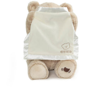 GUND Peek-a-Boo Bear features a satin-accented blanket for tactile contrast.