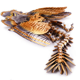 Guwewu Feathered Wyvern Dragon with detailed feathers and dynamic pose on a desk