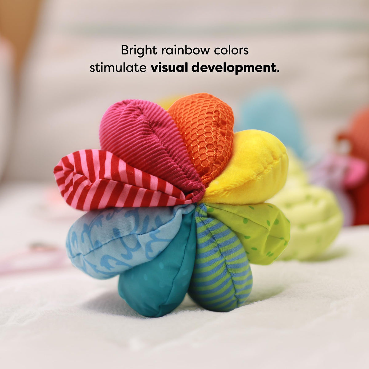 HABA Rainbow Baby Ball promotes grasping, rolling, and gross motor exploration.