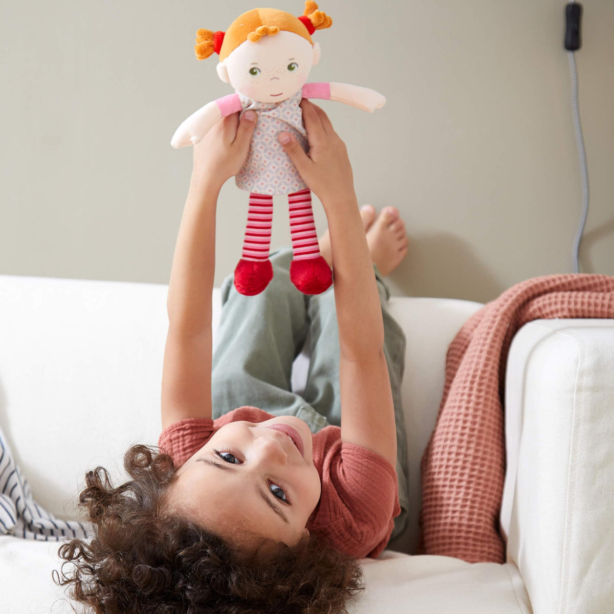 HABA Roya embroidered face detail, safe plush companion for babies.