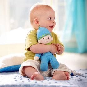 HABA Snug-Up Luis doll, machine washable for easy cleaning after play.